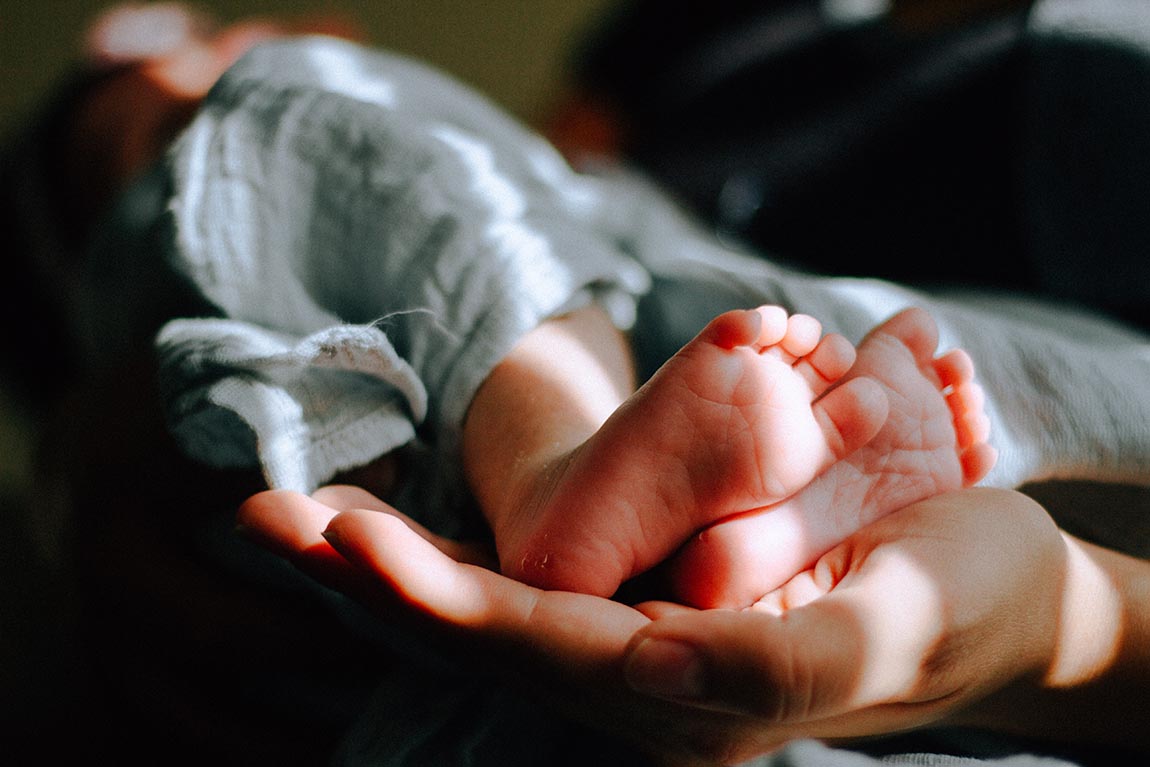 Hands Holding Infant Feet