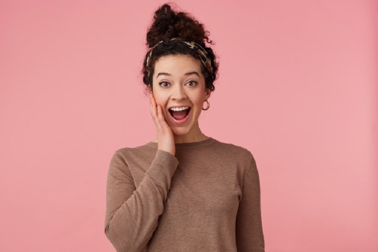 ارگاسم یا ارضا شدن چیست؟ happy amazed young beautiful woman with curly dark hair heard cool news broadly smiling touching cheek looking camera wit wide open aeyes isolated pink background 295783 3081 - ارگاسم یا ارضا شدن چیست؟